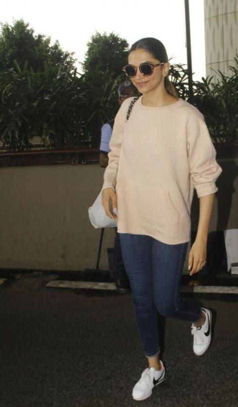 Deepika Padukone styled her white camisole + khaki pants with a roomy  Burberry tote