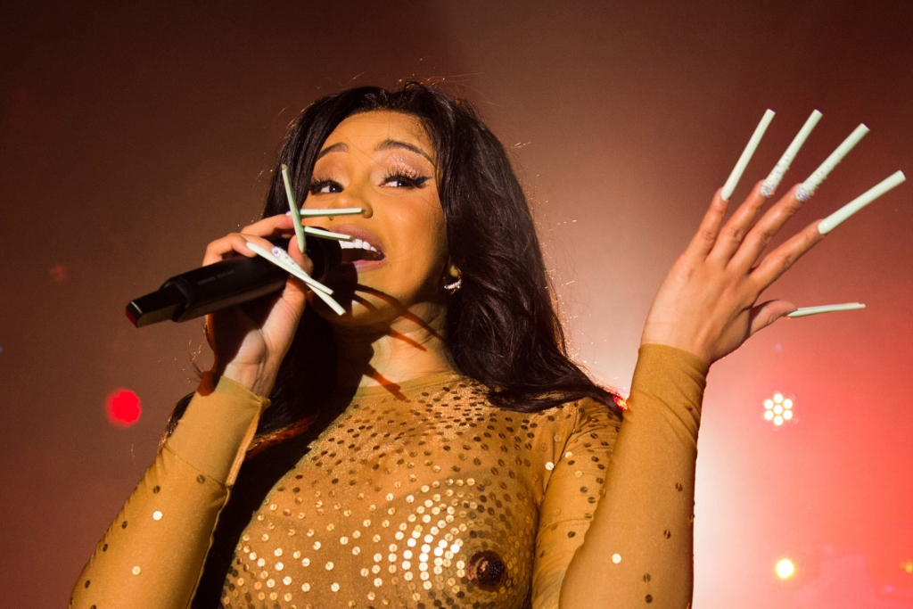 WATCH: Cardi B hurls her mic at fan who threw drink on her